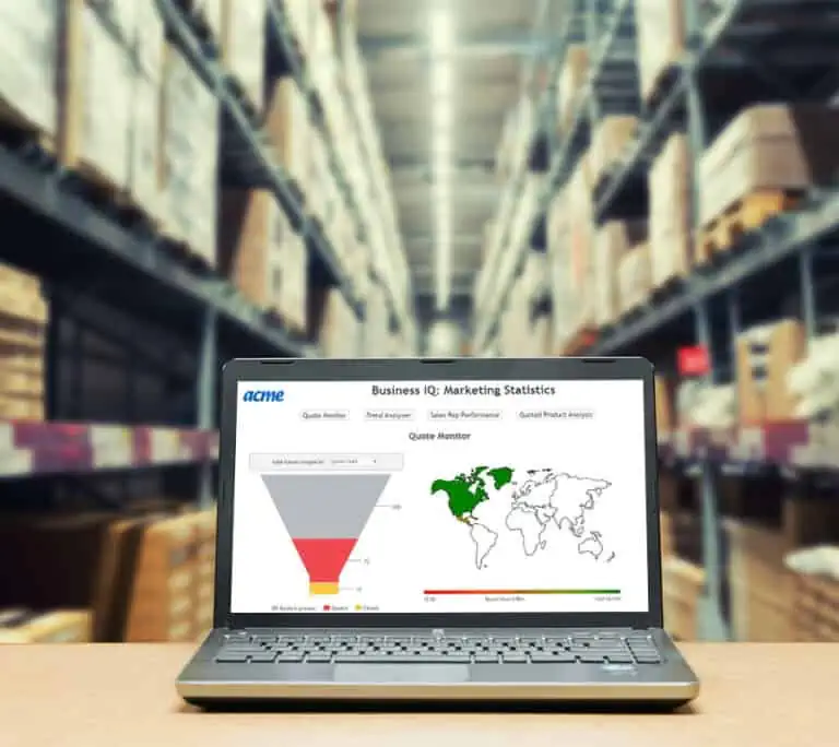 A laptop showcasing Intelliquip Reportings marketing statistics sits on a table in a warehouse. In the background, shelves brimming with boxes underscore the dynamic environment.