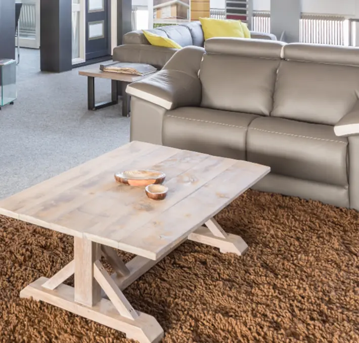 coffee table in front of a leather couch
