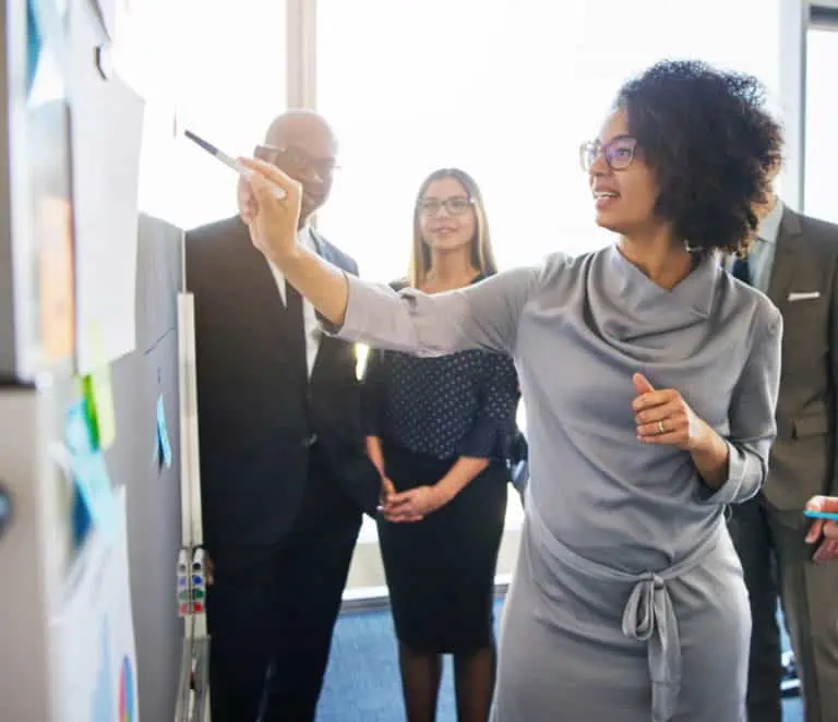 Woman writing on whiteboard
