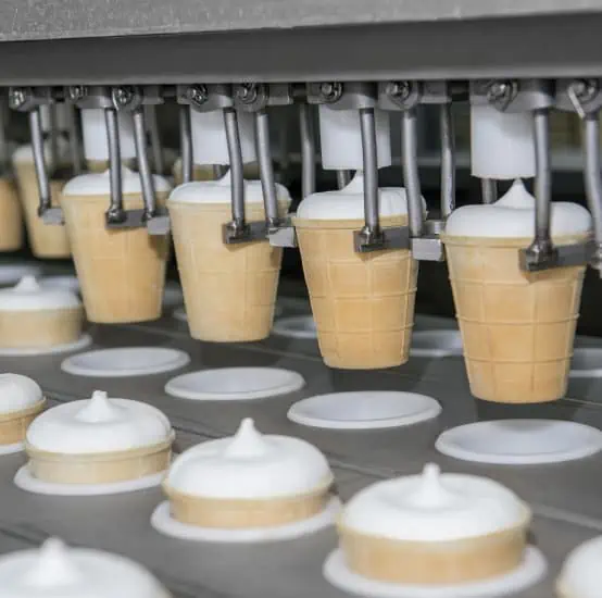 Almondy ice cream cones on an assembly line