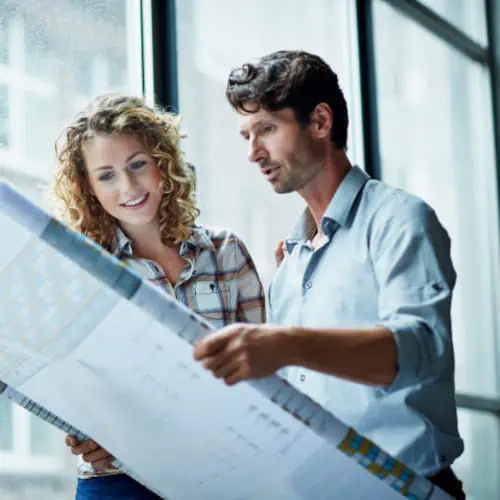 2 people looking at blueprints