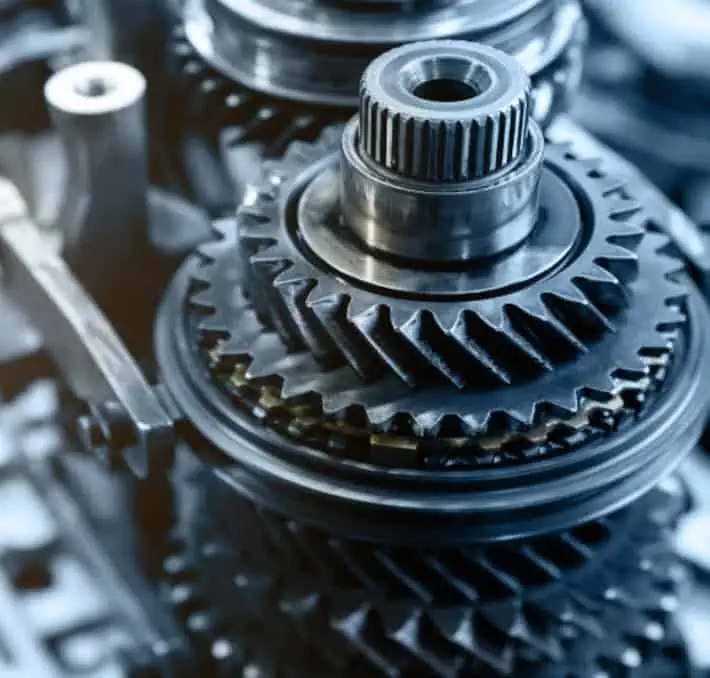 Close-up of metallic gears interlocking, showcasing an intricate mechanical assembly.