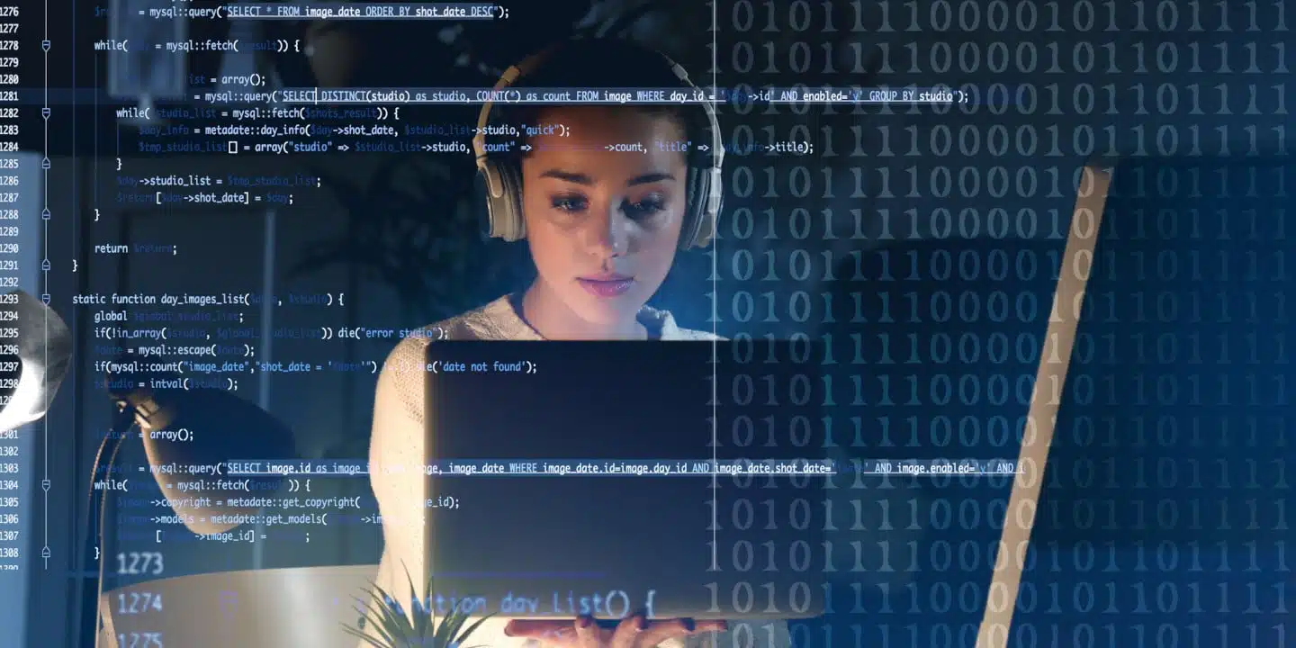 A person wearing headphones works on a laptop, surrounded by digital binary code and quoting software scripts on a transparent screen.