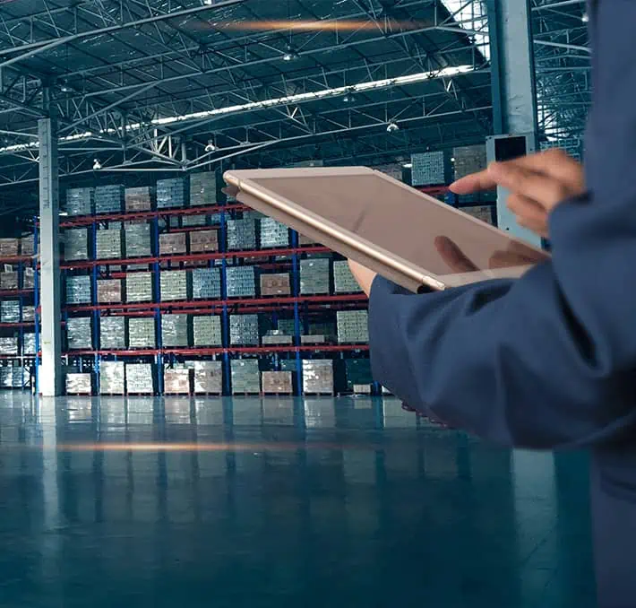 Person with tablet in warehouse