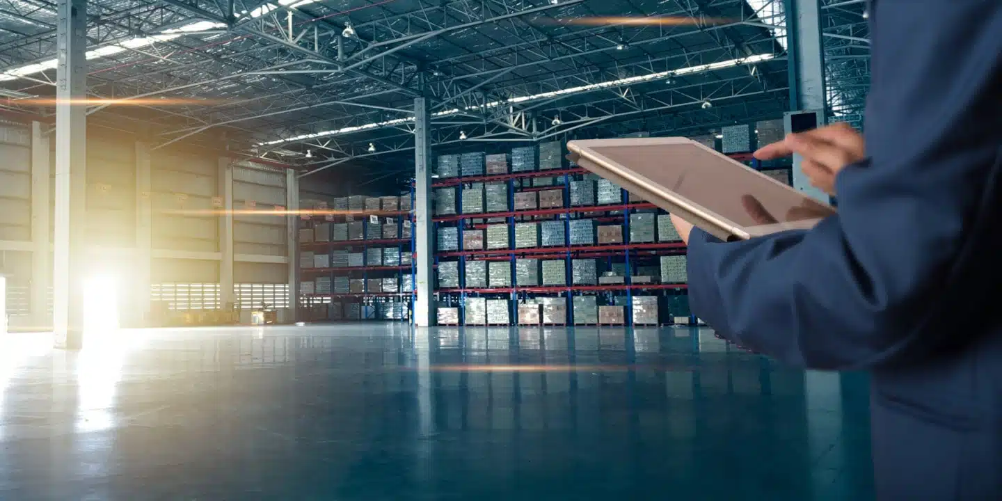 Businessman manager using tablet check and control for workers with Modern Trade warehouse logistics. Industry 5.0 concept