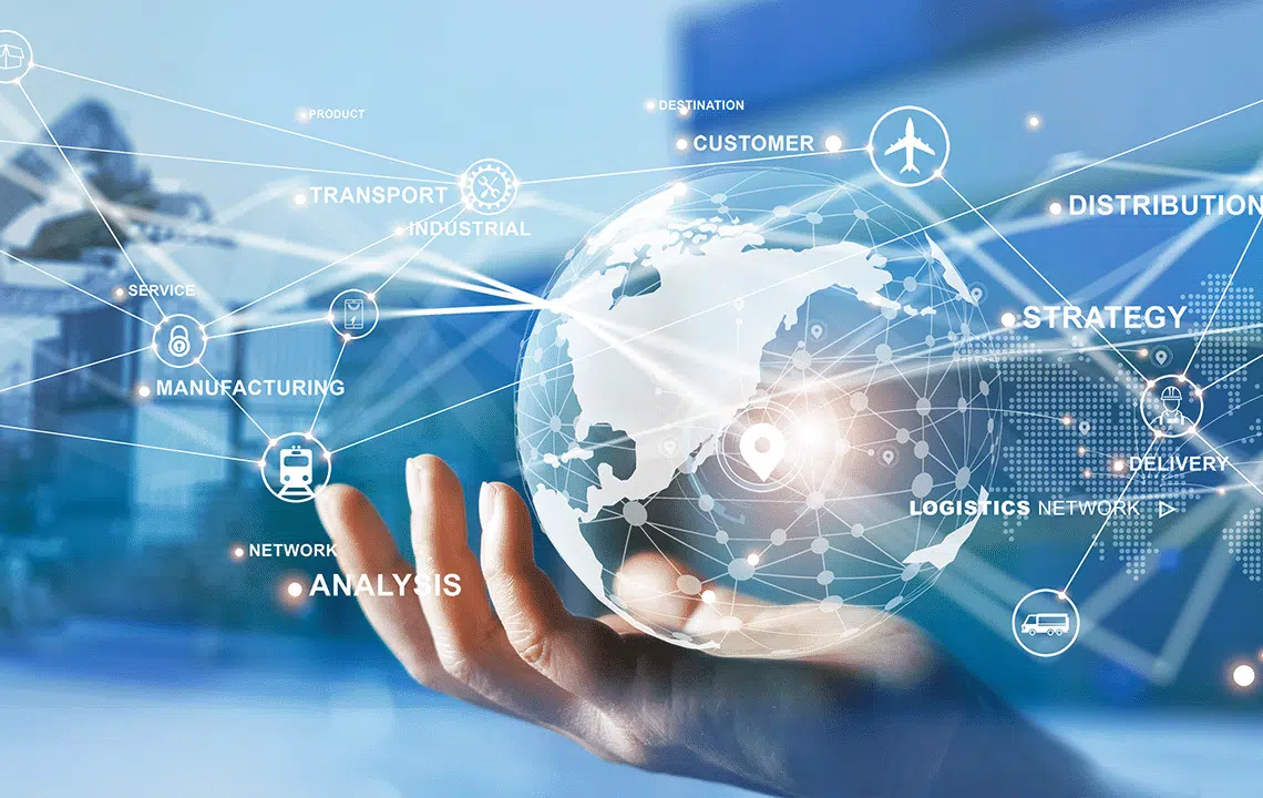 A hand holds a digital globe adorned with interconnected icons, representing logistics, manufacturing, strategy, and supply chain management, symbolizing a comprehensive global business network and analysis.