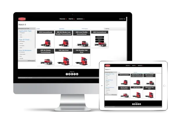Monitor and tablet displaying a website with images of red trucks.