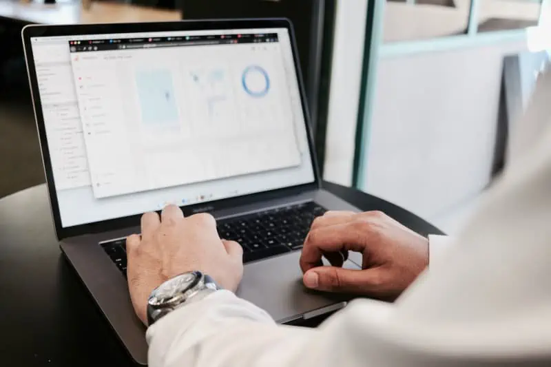 A focused individual is analyzing graphs and charts on their laptop, utilizing SpecQuote to enhance insights and drive strategic decisions.