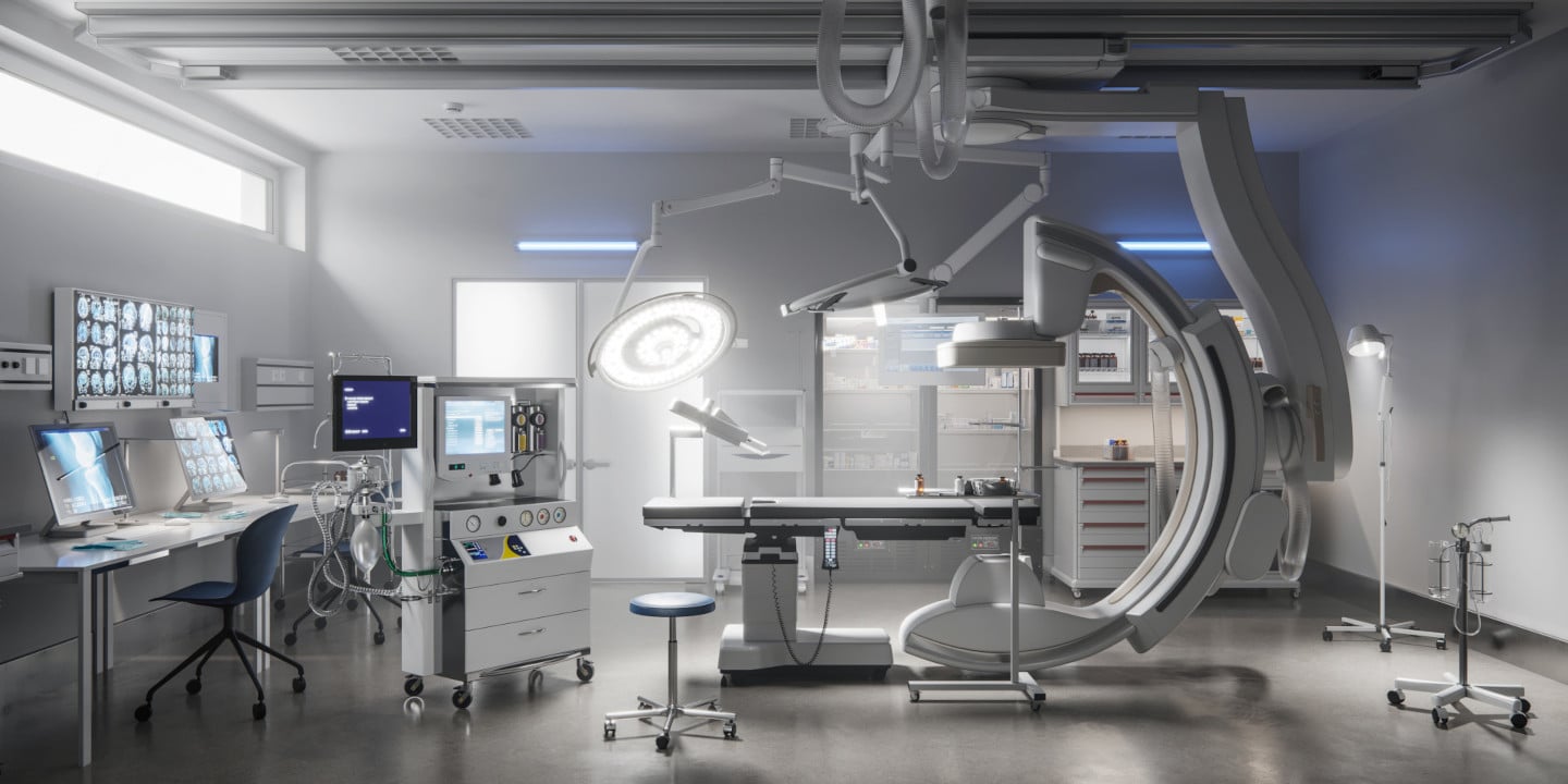 Modern, sterile operating room with advanced medical equipment meeting the highest standards, featuring a surgical table, monitors, and overhead lights, all set for a procedure.