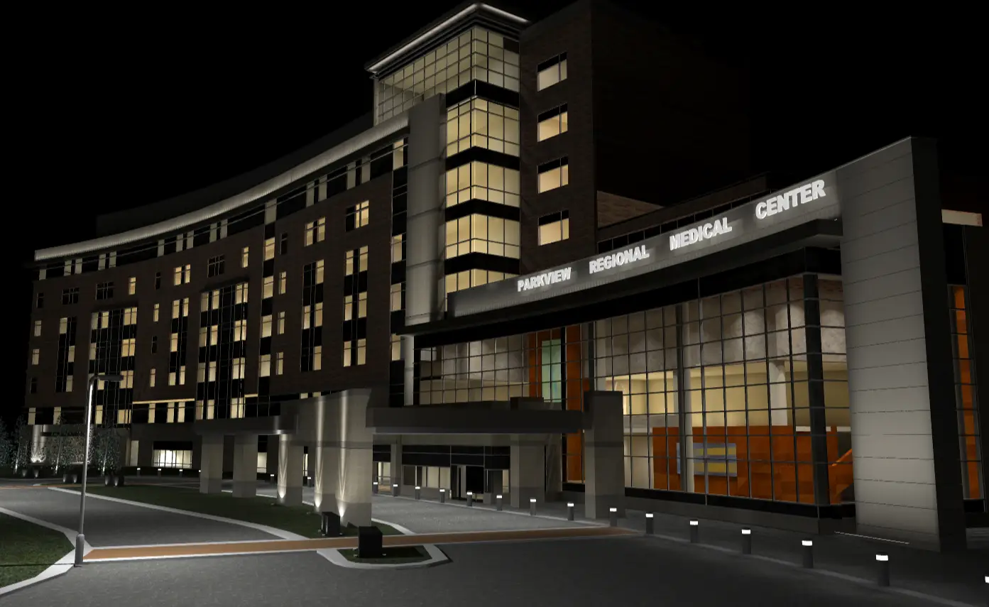 Night view of a modern hospital building with illuminated windows, expertly designed using illuminating engineering software. A sign reading Regional Medical Center glows above the entrance.