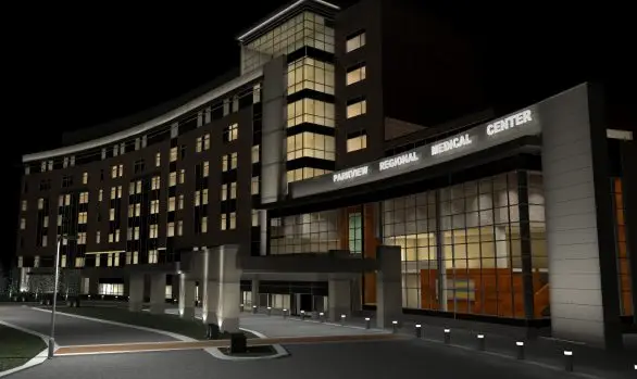 The night view of Parkview Regional Medical Center showcases a multi-story hospital with glowing windows and signs, optimized by illuminating engineering software. The entrance is well-lit, enhanced by beautiful landscaping surrounding the area.