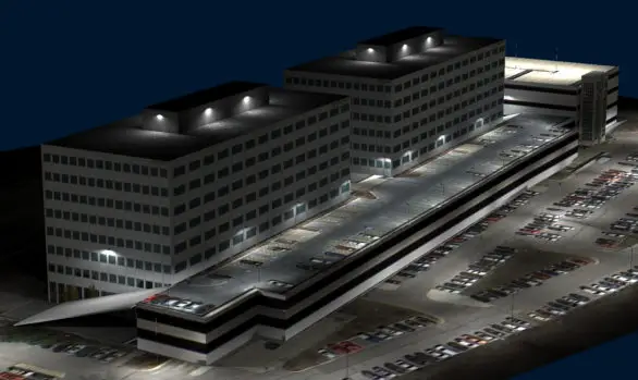 Nighttime view of a large office complex with two rectangular buildings and a central parking area, brilliantly highlighted by exterior lighting designed using sophisticated Illuminating Engineering Software.
