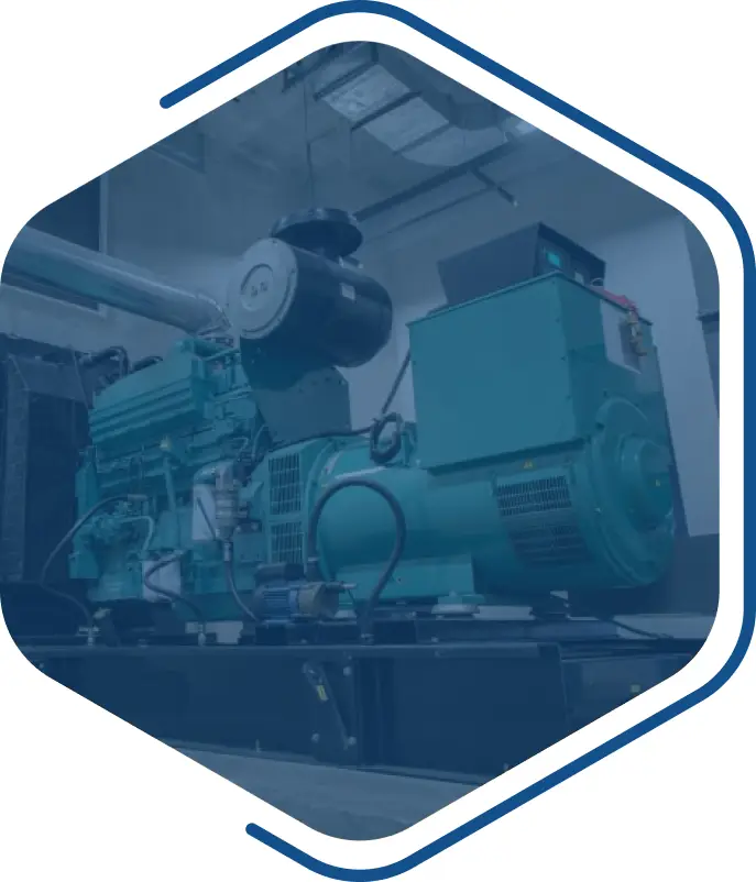 A large industrial generator in a hexagonal frame, with prominent components visible and integrated electrical equipment software. The machinery is predominantly teal and is housed in a room with ducts and pipes overhead.