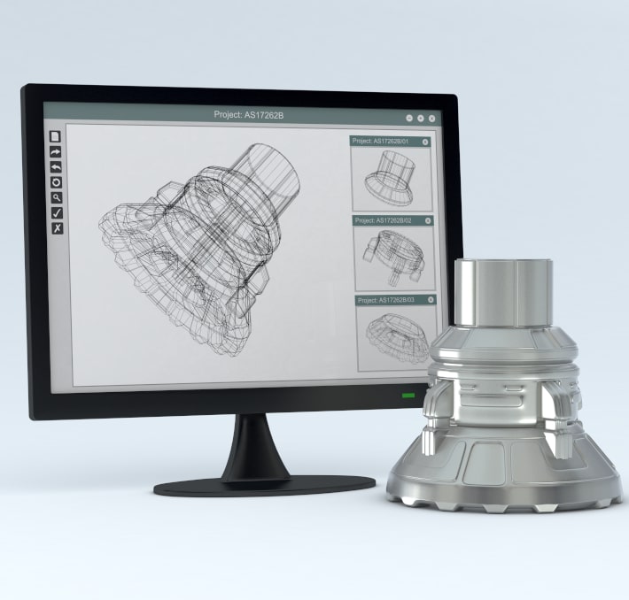 A computer monitor displays a 3D wireframe model of a mechanical part using visual CPQ, with the corresponding finished metal part placed next to the screen.