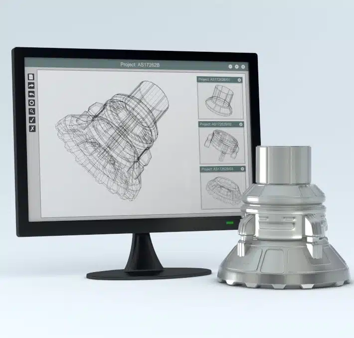 A computer monitor displays a 3D wireframe model of a mechanical part using visual CPQ, with the corresponding finished metal part placed next to the screen.