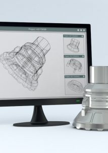 A computer monitor displays a 3D wireframe model of a mechanical part using visual CPQ, with the corresponding finished metal part placed next to the screen.